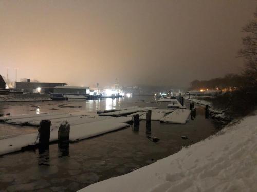 a harbor covered in snow at night with lights at SUNNY SIDE in Kiel