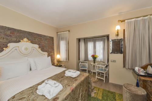 a hotel room with a bed with towels on it at By Murat Royal Hotel Galata in Istanbul