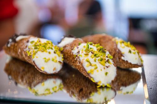a pile of sandwiches on a plate with a spoon at Central Gallery Rooms- Palazzo D'Ali' Staiti XIX in Trapani