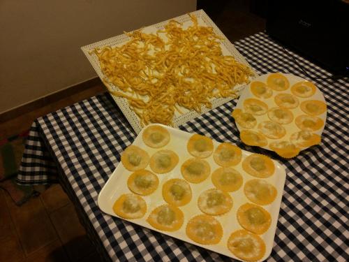 a table with a plate of food and a box of chips at Agriturismo Pretenzano in Volterra