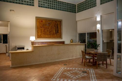 a lobby with a table and a painting on the wall at Olympion Village in Kavos