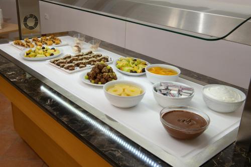 a buffet with different types of food on a table at Olympion Village in Kavos