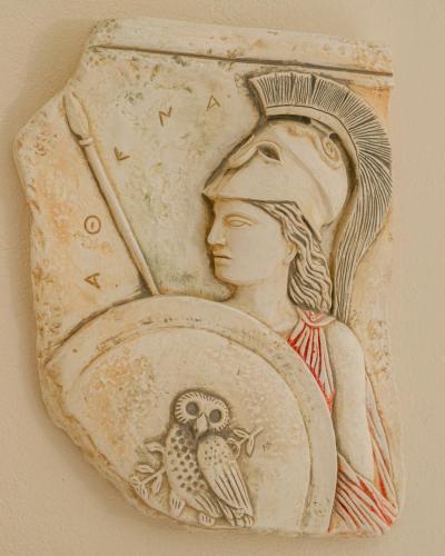 a drawing of a woman with an owl on a plate at Olympion Village in Kavos