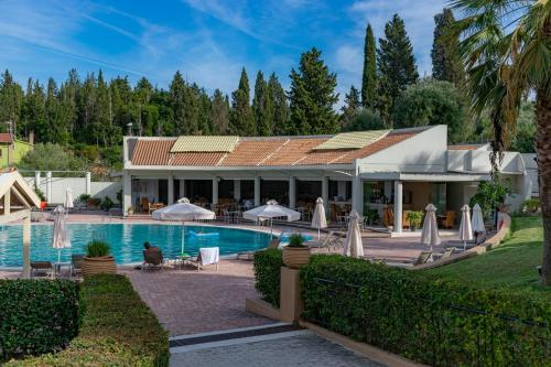 a villa with a swimming pool and a resort at Olympion Village in Kavos