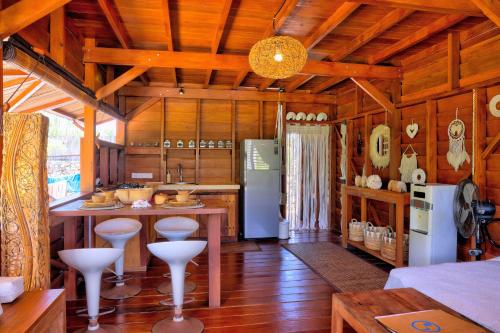 a kitchen with a island in a room with wooden walls at Loedi Bungalows Rote in Nembrala
