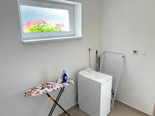 a room with a small refrigerator and a window at Park Rezort with Private Parking in Piešťany