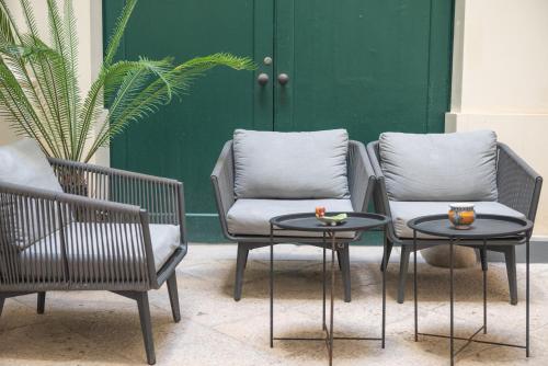 two chairs and a table and two chairs with drinks on them at Central Gallery Rooms- Palazzo D'Ali' Staiti XIX in Trapani