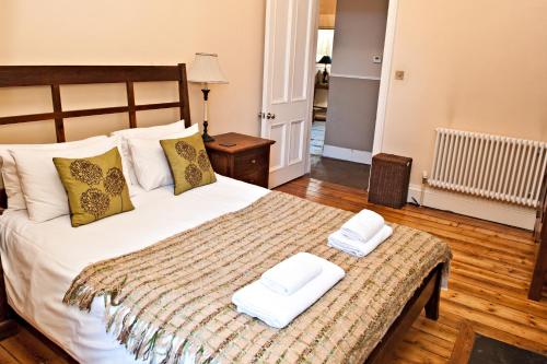 a bedroom with a bed with two towels on it at Haddington Place in Edinburgh