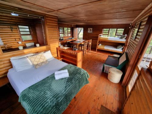 a bedroom with a bed and a table in a room at Mansfield Private Reserve in Port Alfred