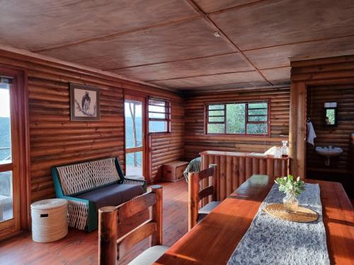 a dining room with a table and a chair at Mansfield Private Reserve in Port Alfred