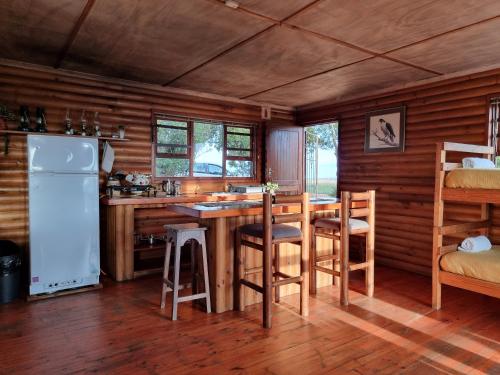 a kitchen with a table and chairs in a cabin at Mansfield Private Reserve in Port Alfred
