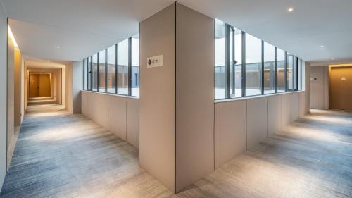an empty corridor with windows in a building at Holiday Inn Express Changsha Kaifu by IHG in Changsha