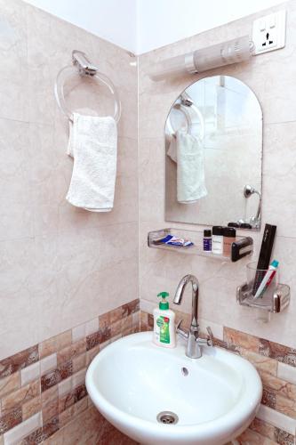 a bathroom with a sink and a mirror at Sweet Inn in Bhaktapur