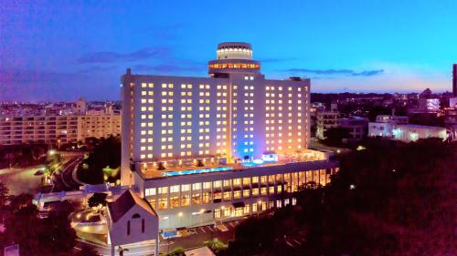 a large building with a tower on top of it at Novotel Okinawa Naha in Naha