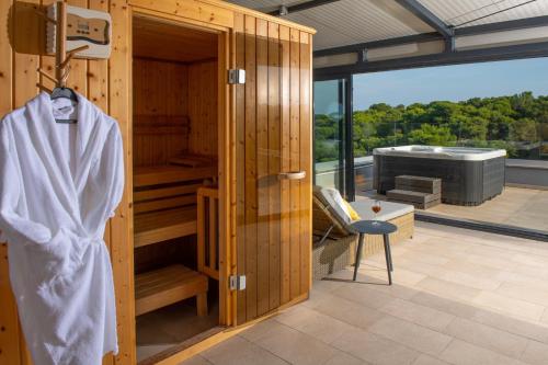 a wooden room with a sauna and a tub at Aparthotel Punta Blu - POOL & SPA in Premantura