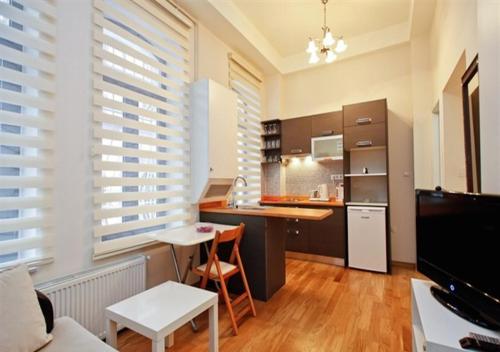 a kitchen with wooden floors and white blinds at Bianco Residence Taksim in Istanbul