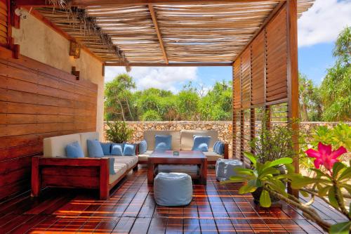 an outdoor patio with couches and a table at Loedi Bungalows Rote in Nembrala