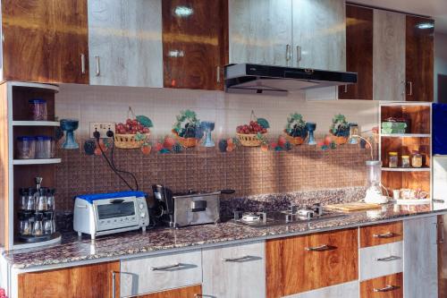 a kitchen with a counter with a toaster and a microwave at Sweet Inn in Bhaktapur