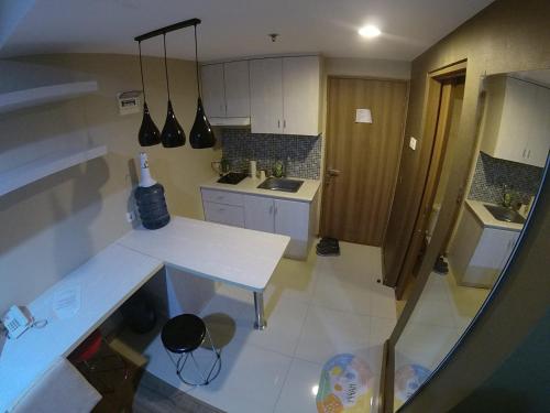 an overhead view of a kitchen with a white counter at Student Park 828 by We Stay in Seturan
