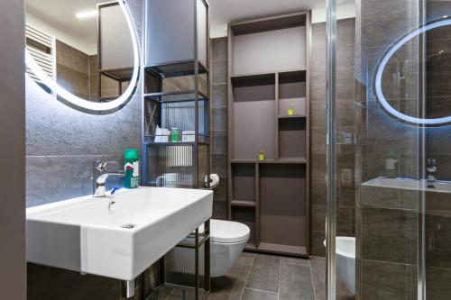 a bathroom with a sink and a toilet and a shower at Camplus Guest Firenze Casa per Ferie in Florence