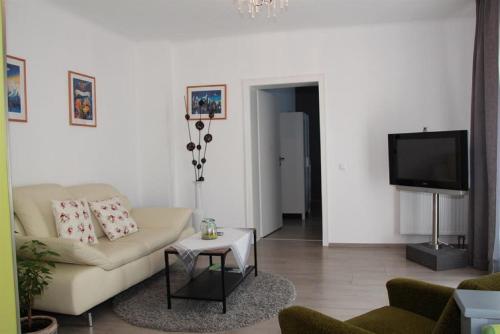 a living room with a couch and a tv at Ferienwohnung Grete in Merzig