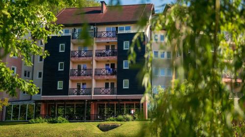 a view of the front of a building at Terme Olimia - Aparthotel Rosa in Podčetrtek