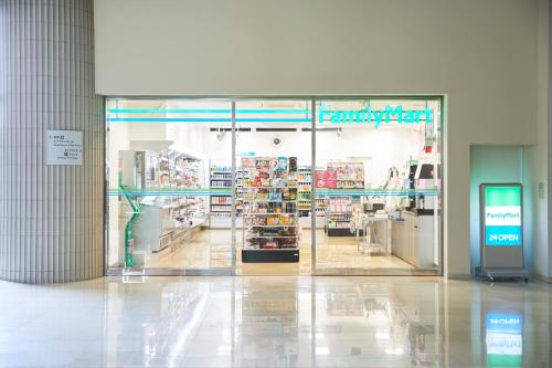 a store with a glass door in a shopping mall at HOTEL MYSTAYS PREMIER Narita in Narita