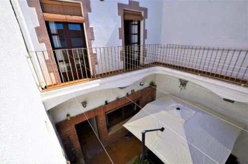 an umbrella on the balcony of a building at LUXURY HOUSE 8 PERSONS FRONT THE BEACH BLANES COSTA BRAVA in Blanes