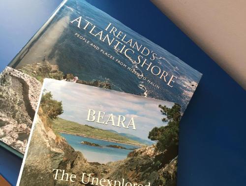 a book on the cover of a mountain shop at Laughing Seagull Cottage - unspoilt sea views in Castletownbere