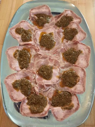 a blue plate with meat and spices on a table at Agriturismo IL FRA' in Tigliole