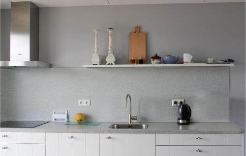 a kitchen with a sink and a counter top at Stunning Home In Wieringerwerf in Wieringerwerf
