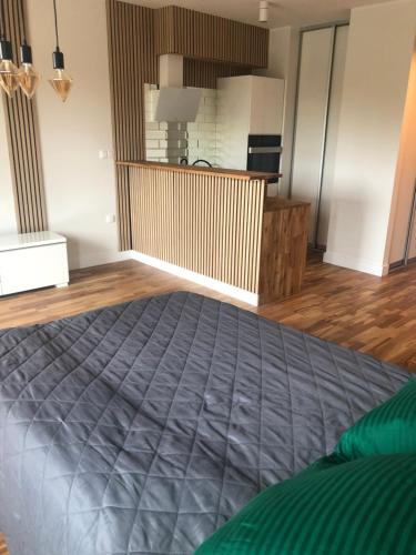 a bedroom with a bed in a room with wooden floors at Apartment Warszawa in Warszawa