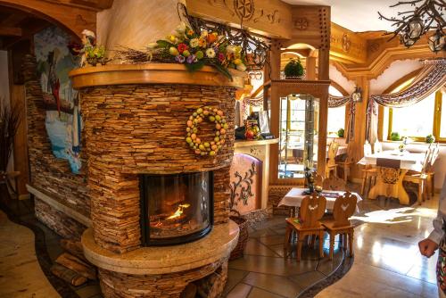 a living room with a stone fireplace in a restaurant at Hotel Burkaty in Białka Tatrzanska