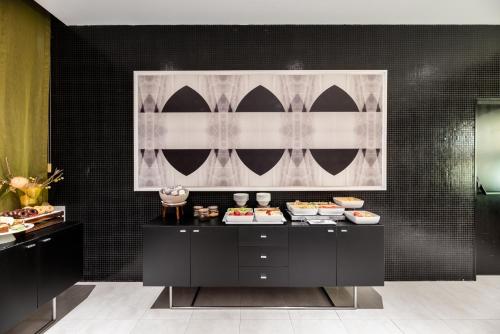 a buffet in a room with food on it at Exe Zizur Pamplona in Zizur Mayor