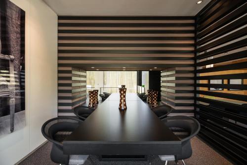 a conference room with a long table and chairs at Exe Zizur Pamplona in Zizur Mayor