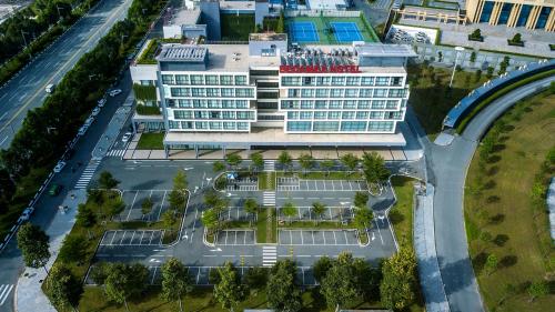 an overhead view of a hotel building with a parking lot at Becamex Hotel New City in Thu Dau Mot