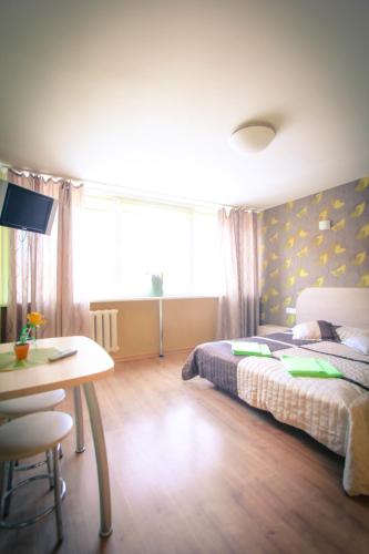a bedroom with a bed and a desk and a table at Silvana in Vilnius