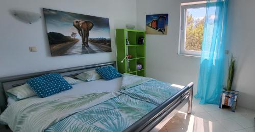 a bedroom with a bed with a picture of an elephant at Villa Jagoda in Sveta Nedelja