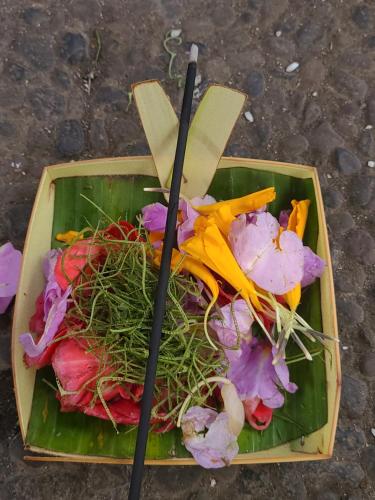 a plate of vegetables with chopsticks on top of it at Batur lake view in Kintamani