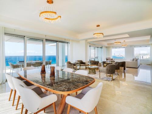 a living room with a table and chairs at The Tower at St Raphael Resort in Limassol