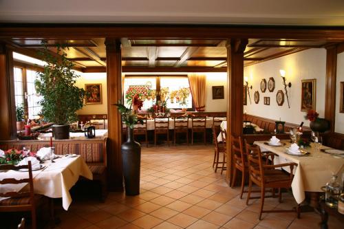 a dining room with tables and chairs in a restaurant at Hotel-Restaurant Bierhäusle in Freiburg im Breisgau