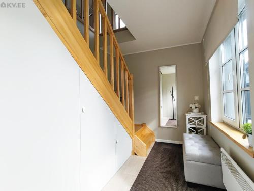 a room with a staircase with a couch and a window at Karjamaa Apartment with Garden in Pärnu