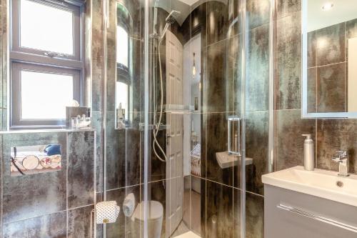 a bathroom with a shower and a sink at Armando in Truro