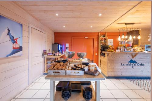 a bakery with a table with food on it at Hotel Le Bois Joli in Bernex