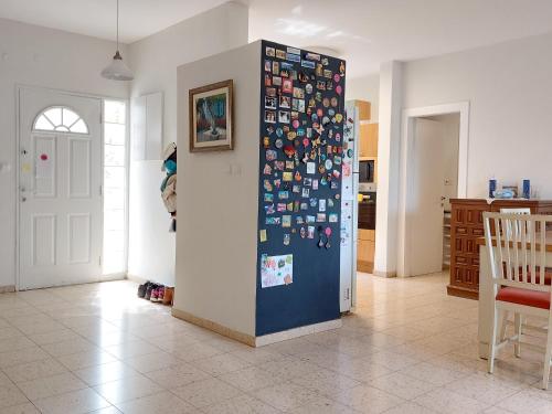 a wall with many magnets on it in a room at Happy Vacation House in Zikhron Ya‘aqov