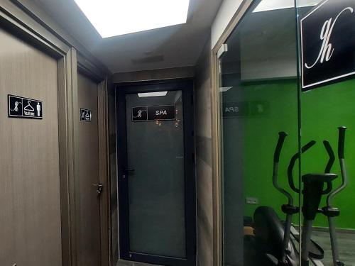 a elevator with a green door in a room at El Ghanami Hotel in Alger