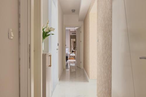 a hallway of a house with a vase of flowers at Moderna Luxury Apartments with HEATED pool in Tivat