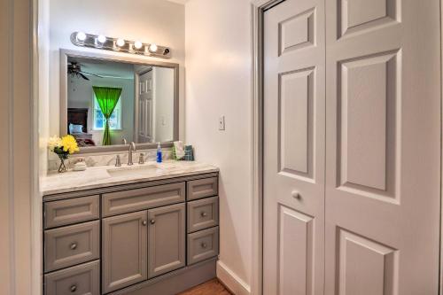 a bathroom with a sink and a mirror at Convenient Jacksonville Home with Yard and Patio! in Jacksonville