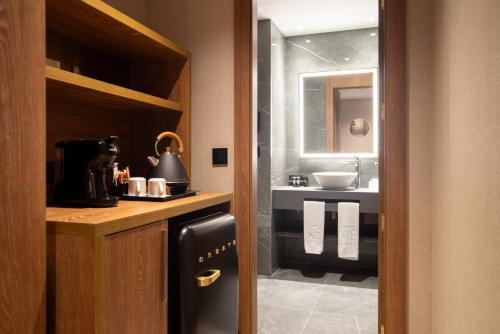 a kitchen with a sink and a black refrigerator at Hotel Granada Center in Granada