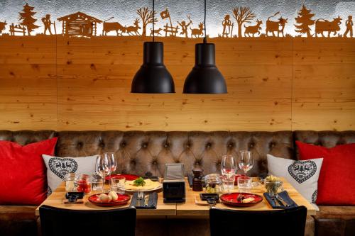 a table in a restaurant with wine glasses on it at Hotel Sport Klosters in Klosters